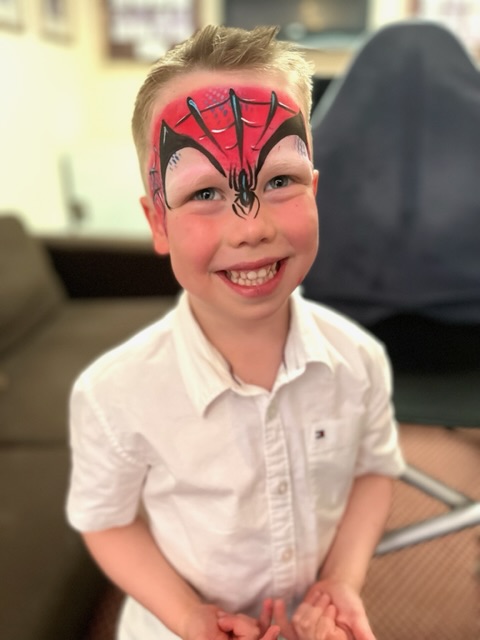 boy with spiderman face paint in Shifnal
